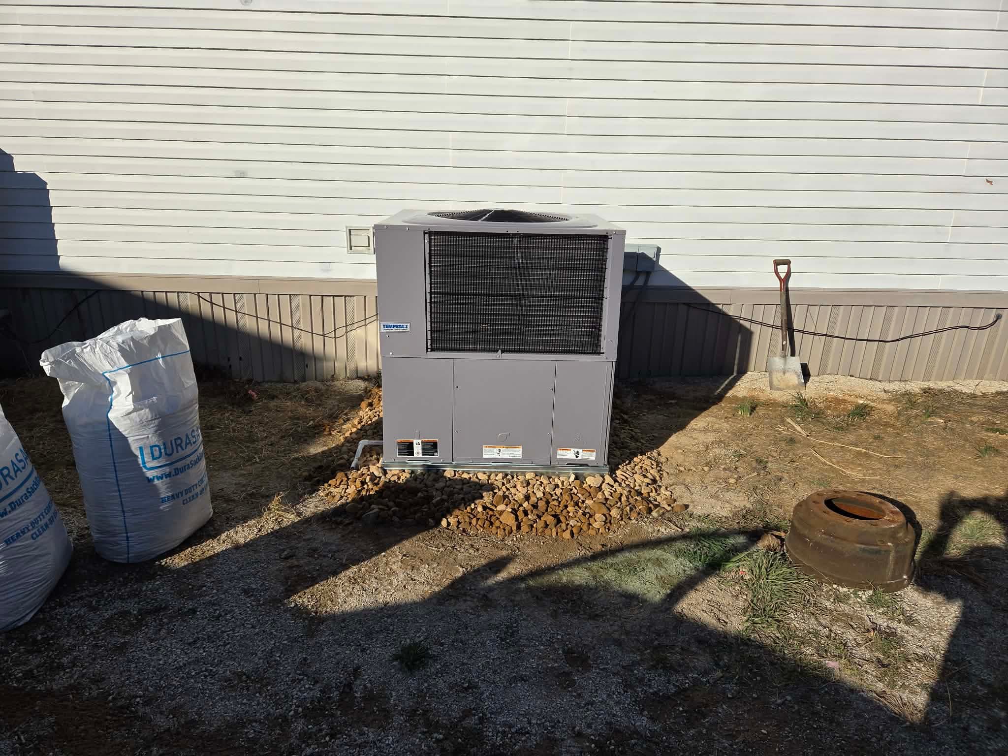 After: new package unit on a fresh gravel base at a Cleveland home